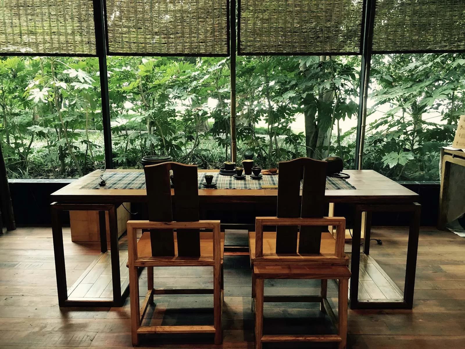 Antique dining table and chairs with greenery in a classic interior