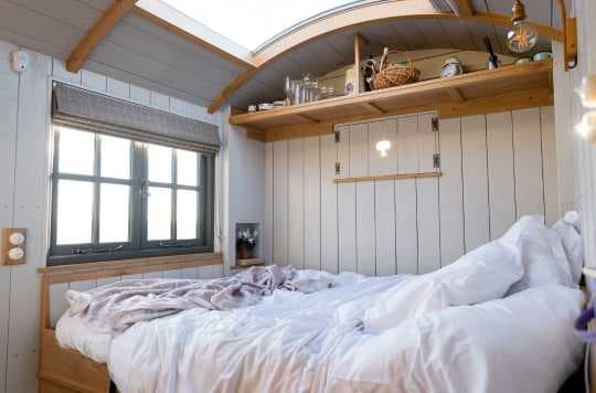 use of space in tiny house above bed