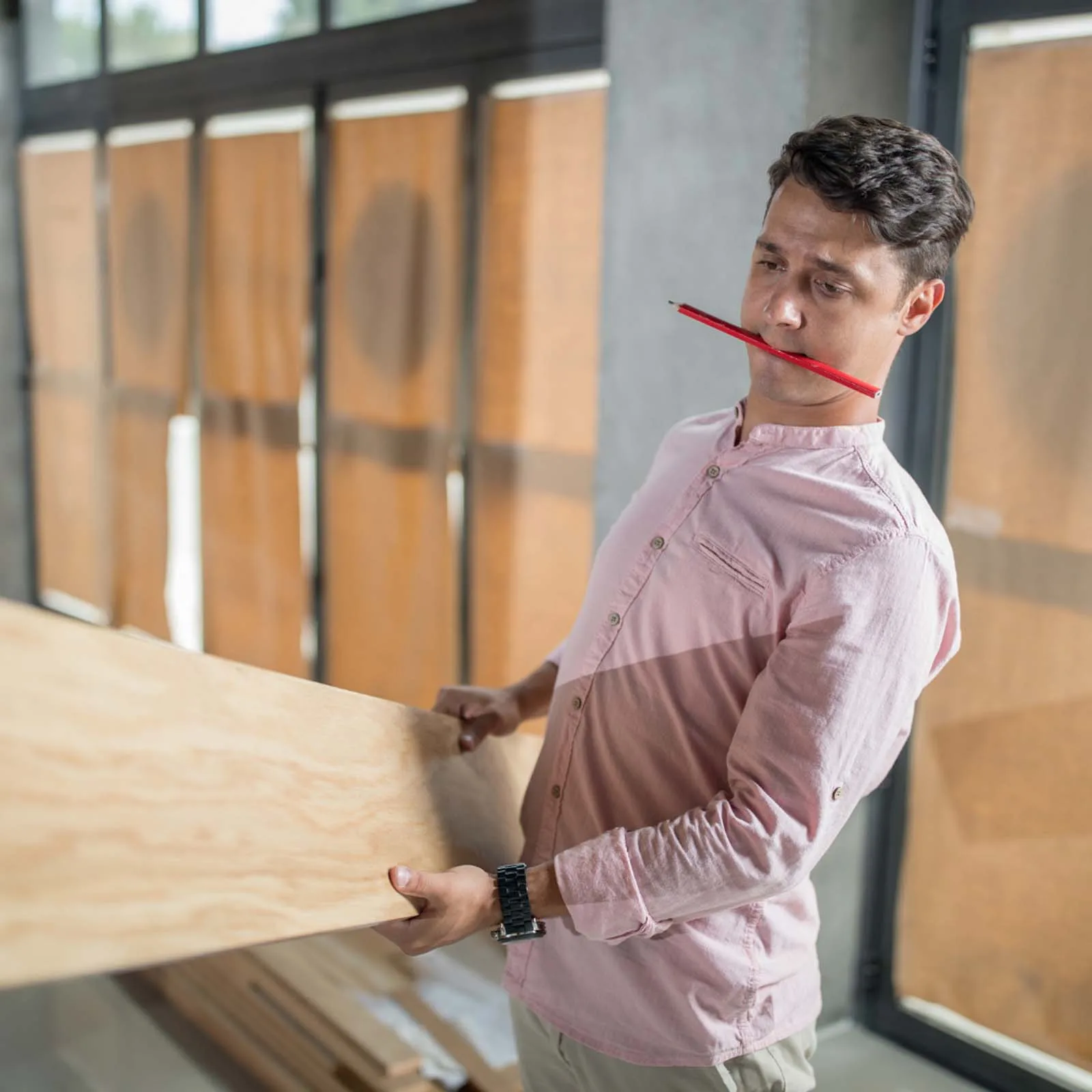 Construction site with materials and a contractor reviewing plans