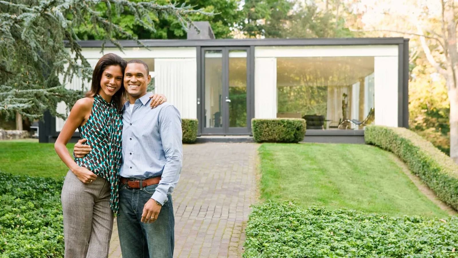 A couple standing in front of a modern ADU