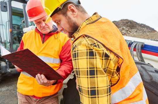 checking building permit paperwork for a construction project