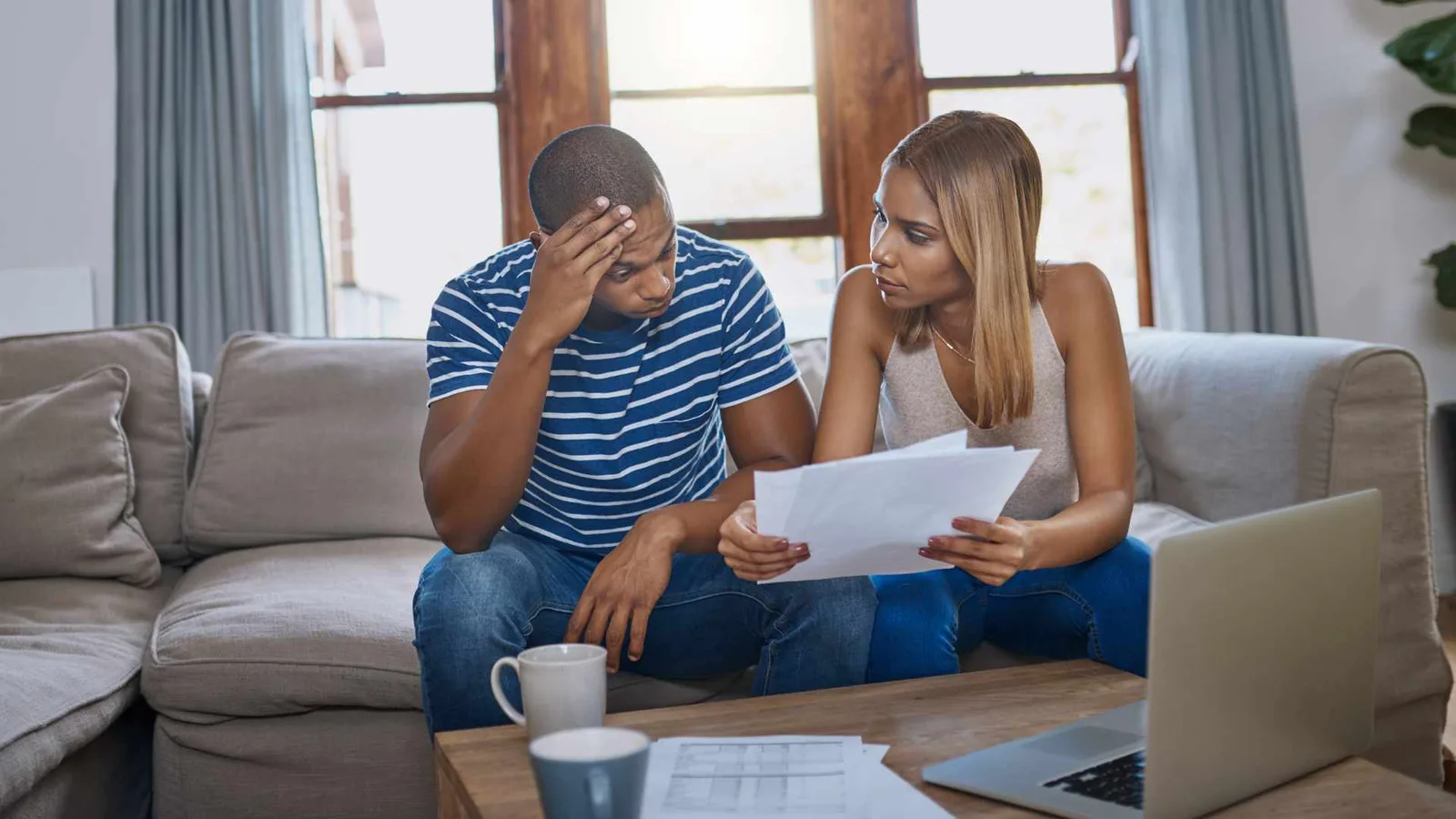 Couple reviewing ADU cost paperwork at home