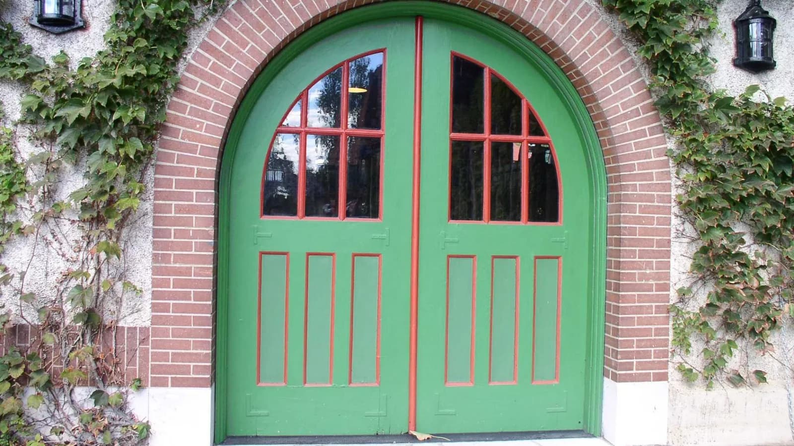 Large paneled wooden doors at the entrance to a carriage house