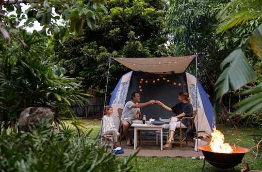 family in the backyard with fireplace