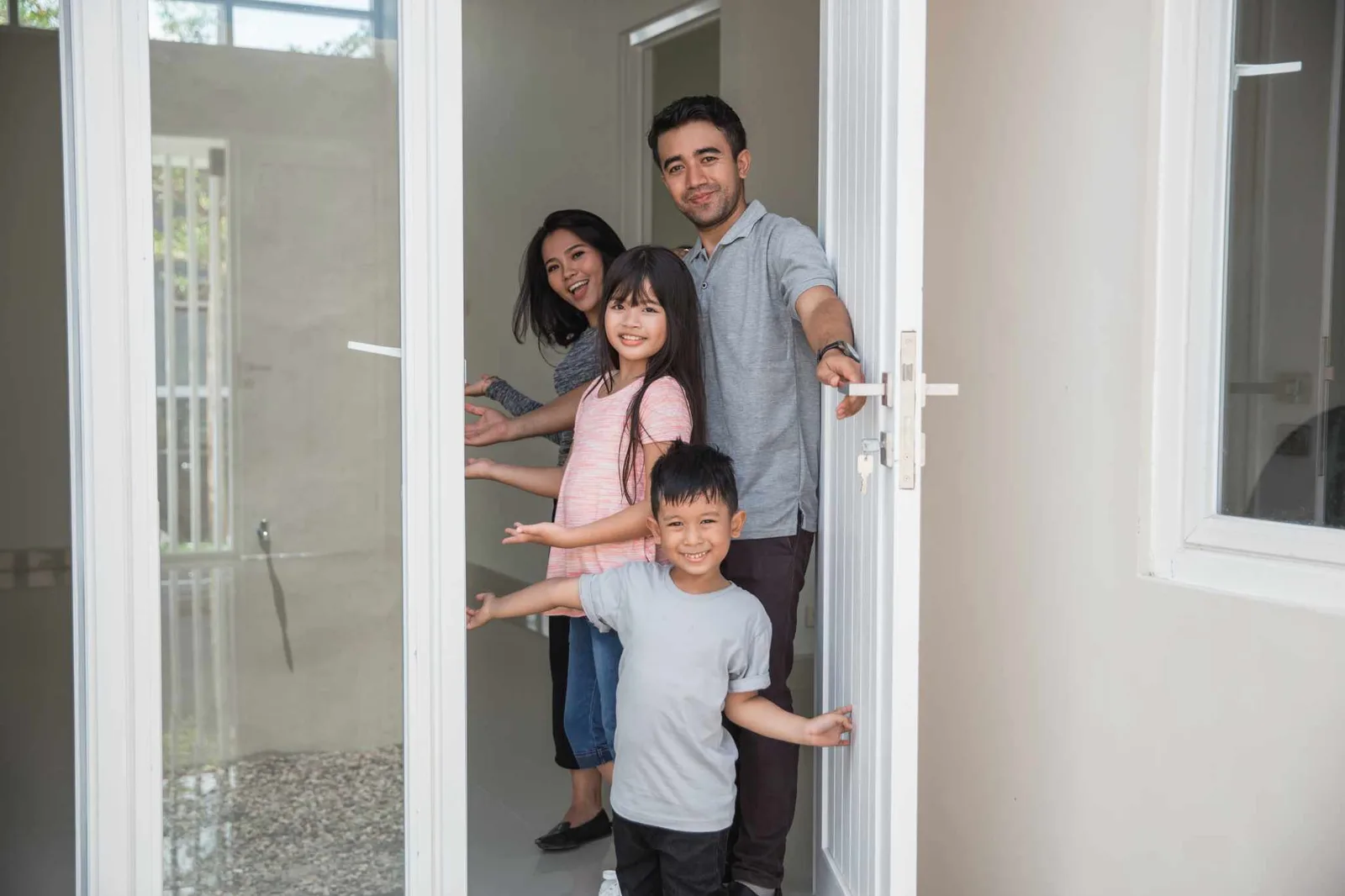 family of four welcoming guests