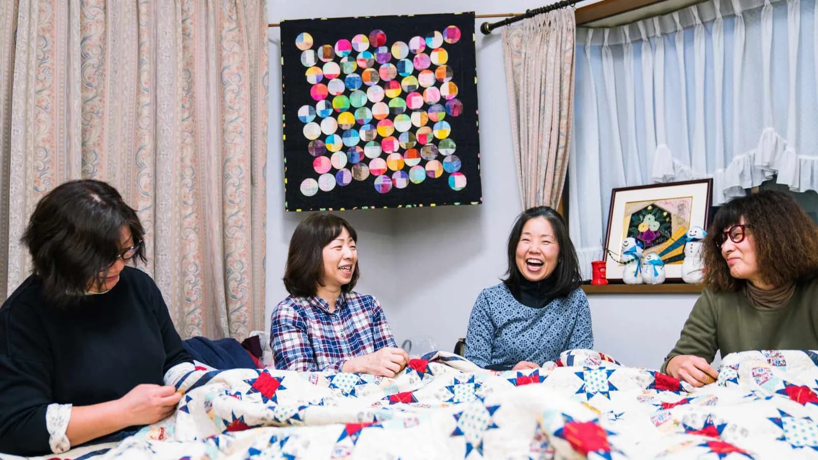 friends making a quilt together