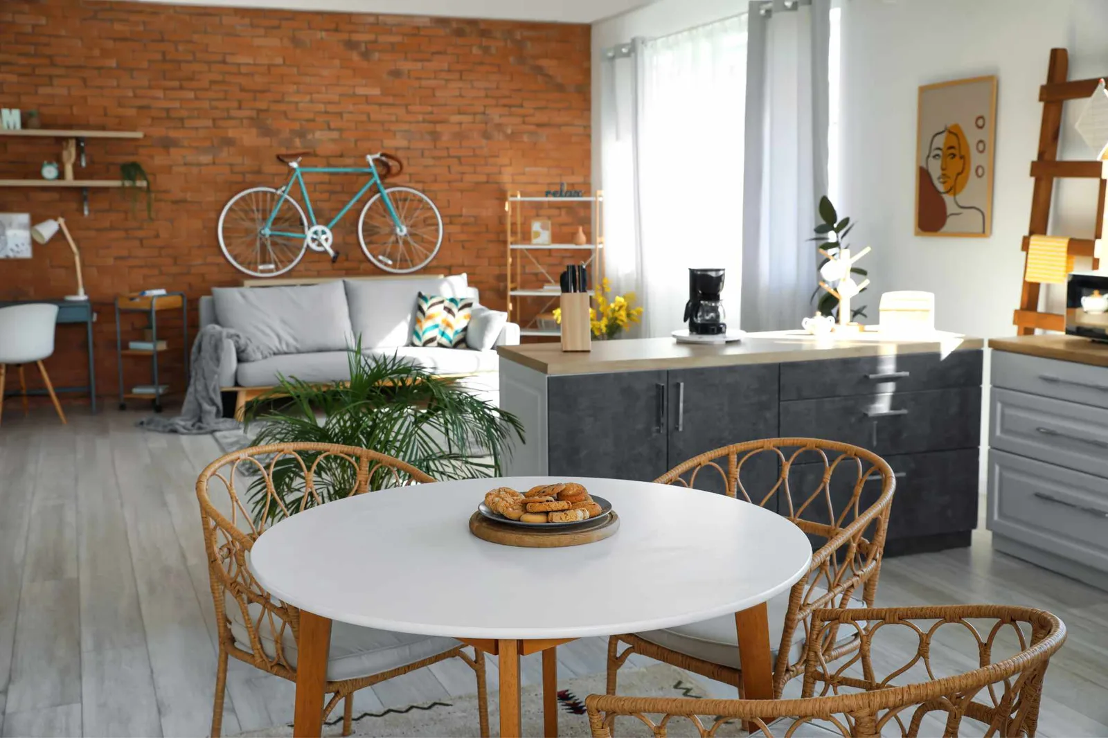 garage conversion with brick wall showing sofa and dining area