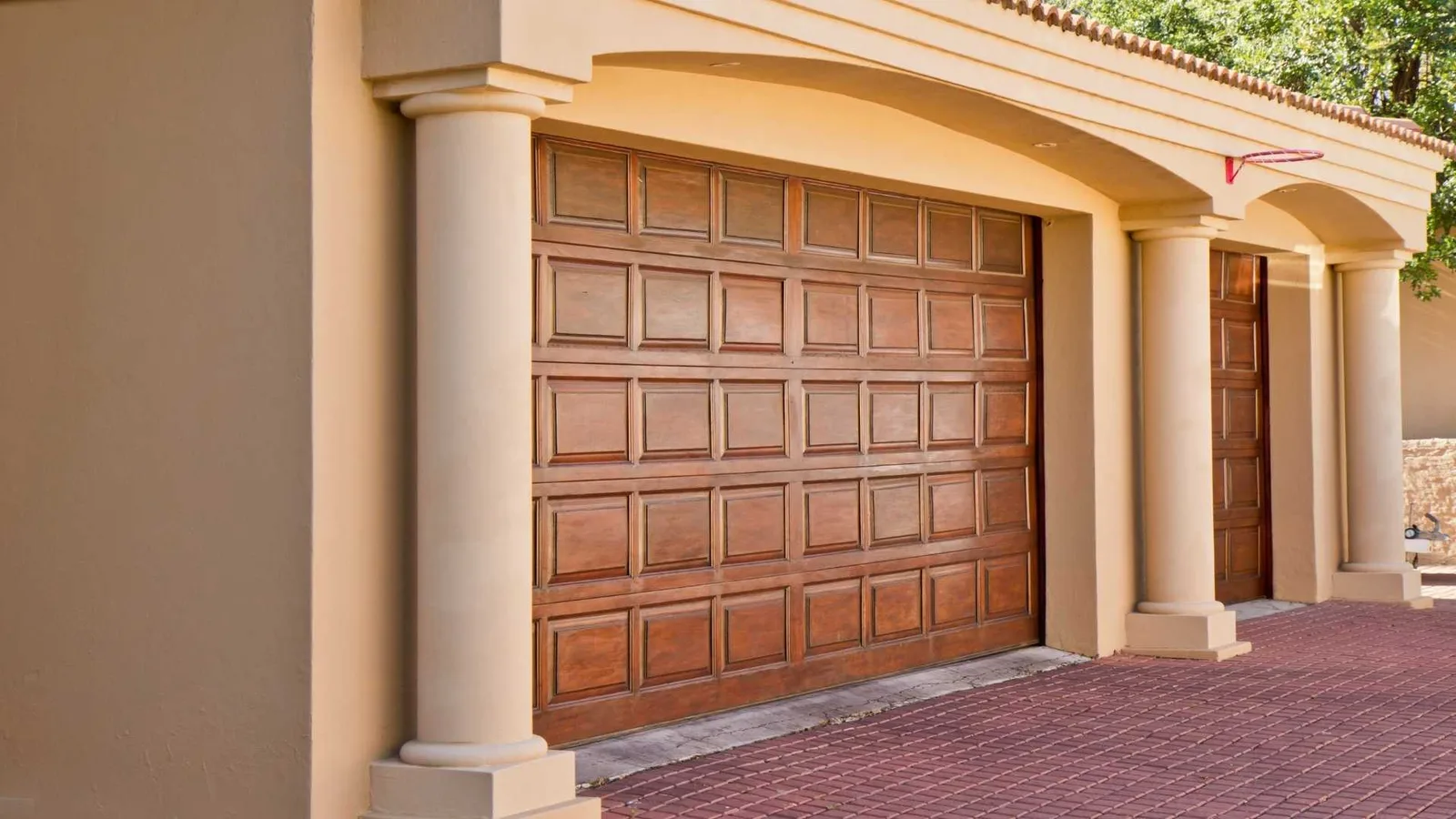 Carriage house with wide carriage-style garage doors