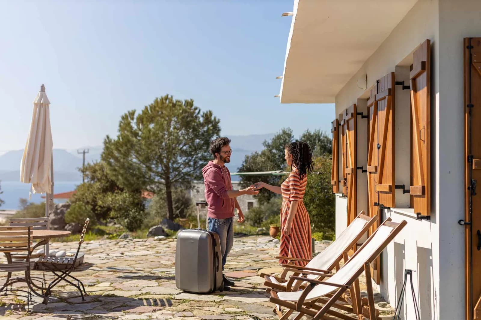 guest with suitcase by the guest house