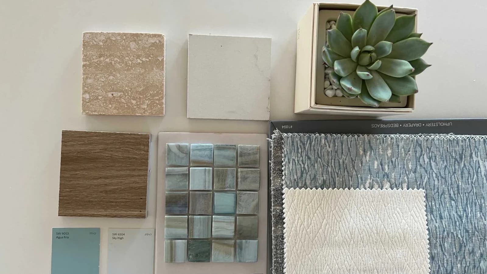 Home WiP interior design with light blue glass mosaics and travertine