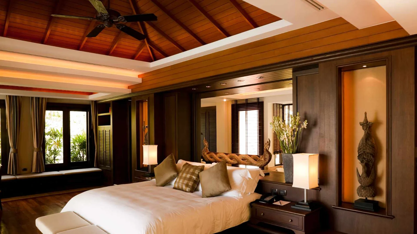 interior design of a studio with vaulted ceiling and fan