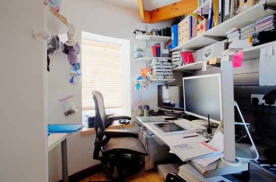 Cluttered home office corner inside a house