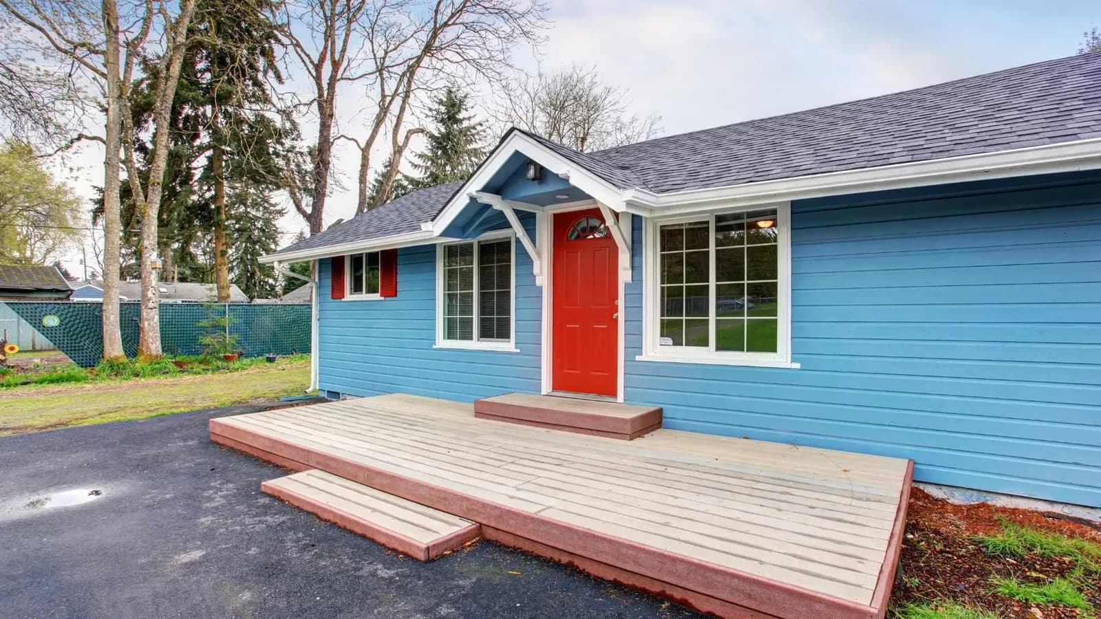 Prefabricated ADU with a red door, landing, and steps