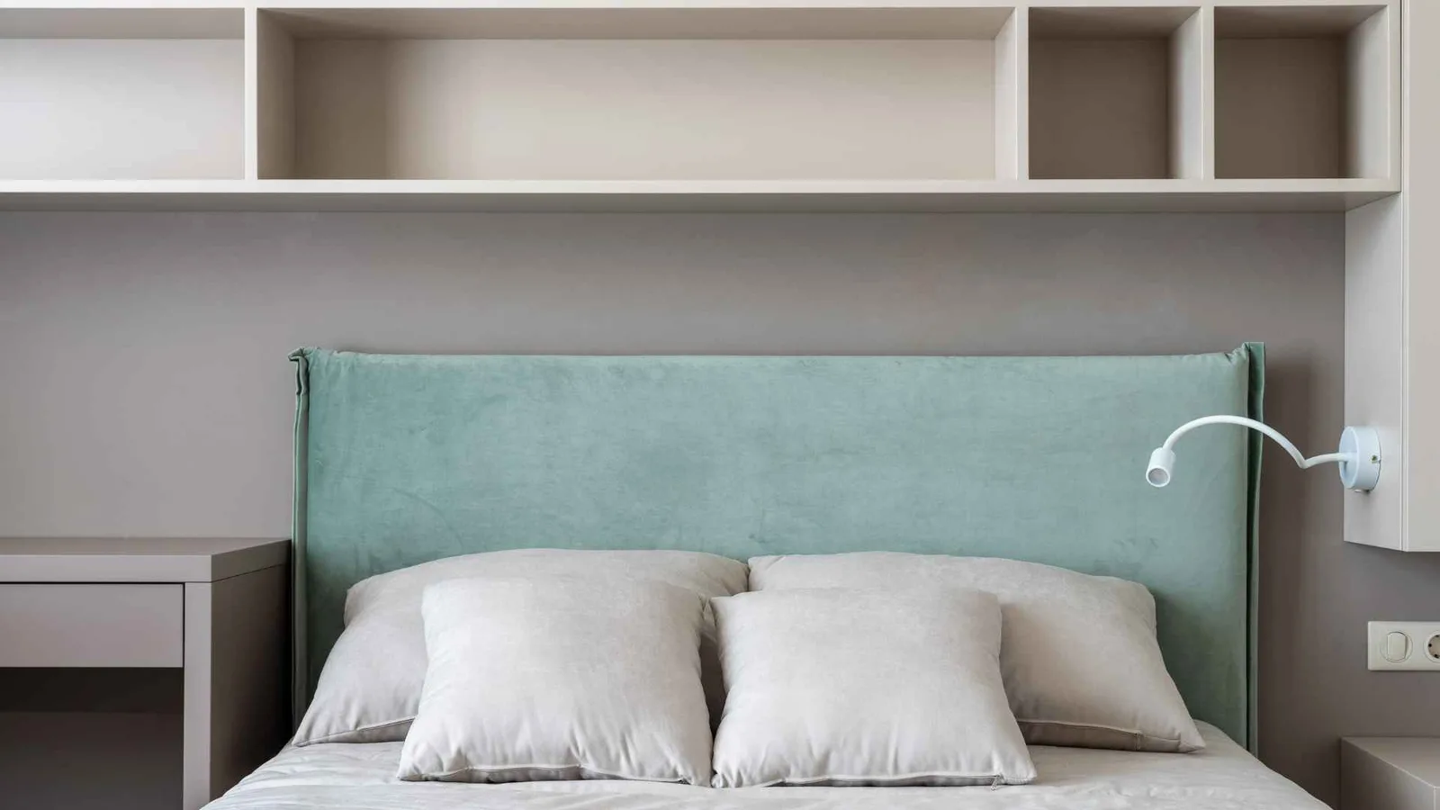 Built-in storage cabinets above the bed in a tiny home