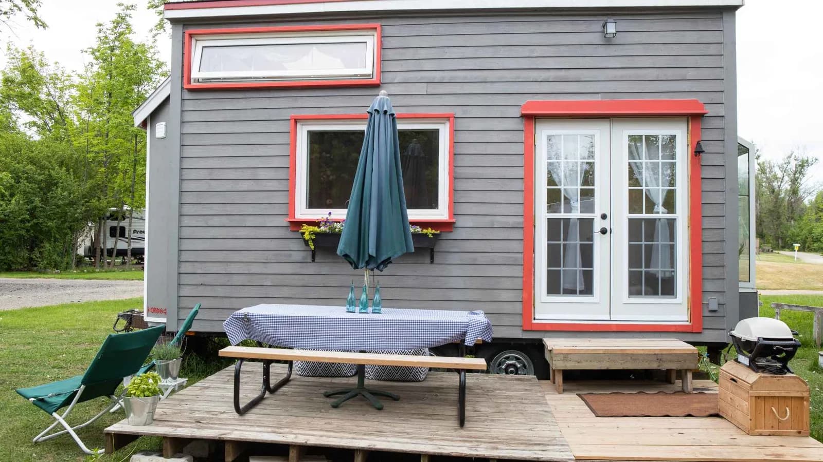 Outdoor deck space extending a compact tiny home