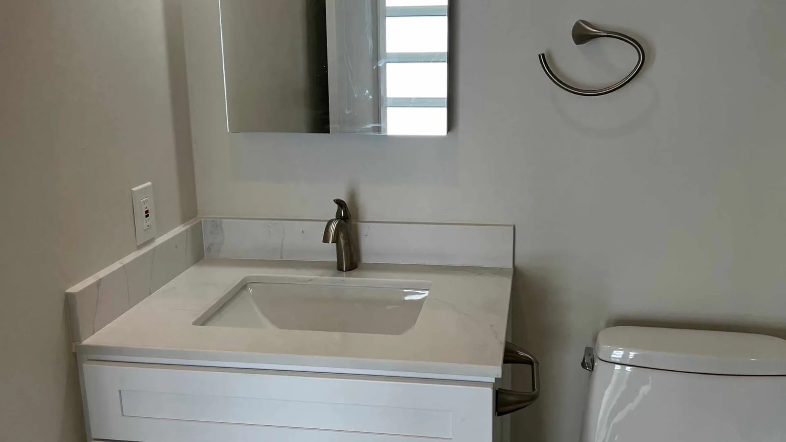 vanity and medicine cabinet in a converted garage