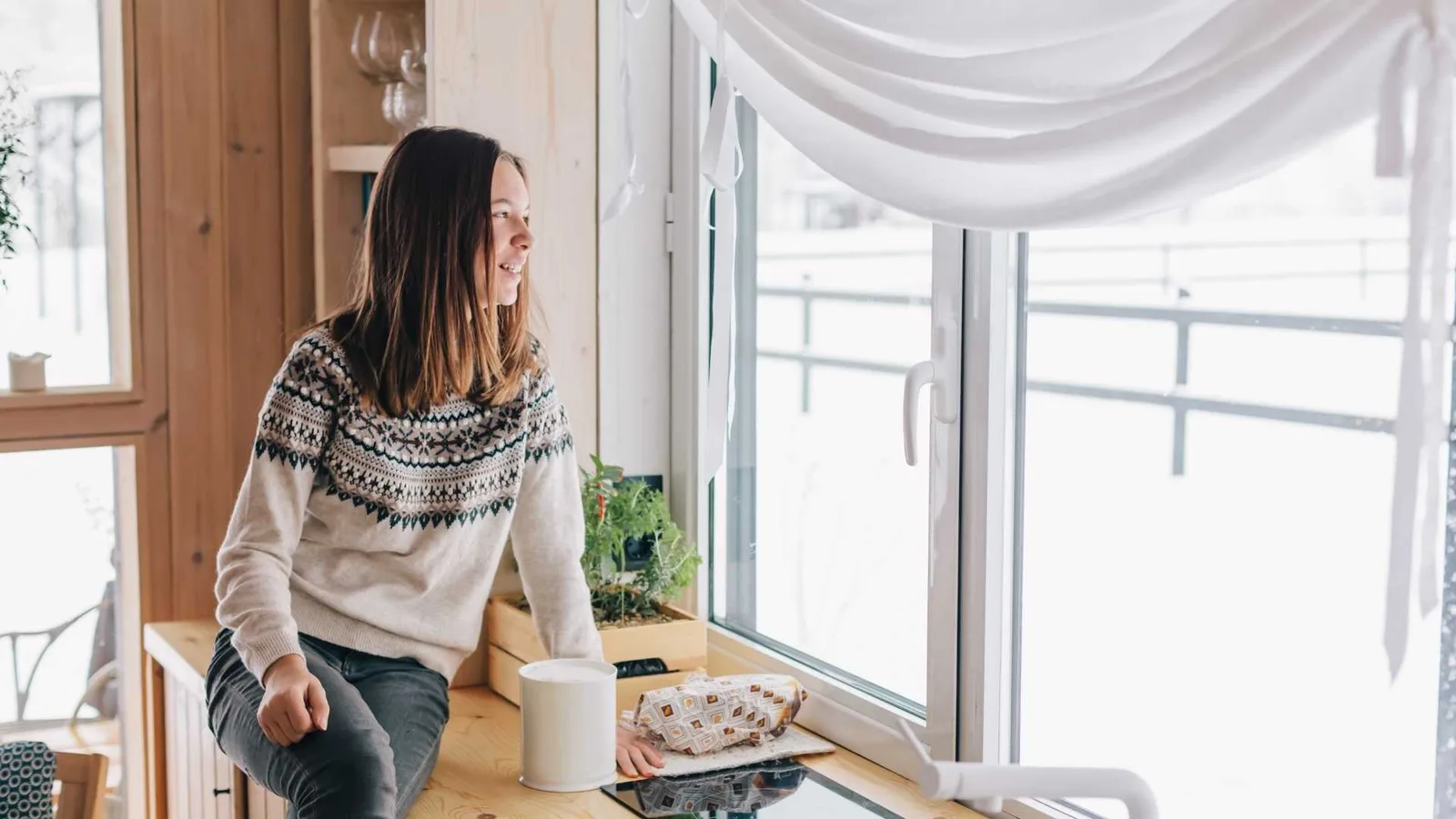 Woman by the window in a cabin